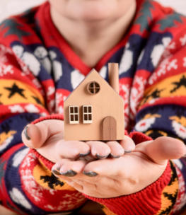 a-woman-holds-a-toy-house-in-her-hands-2025-01-10-05-24-29-utc